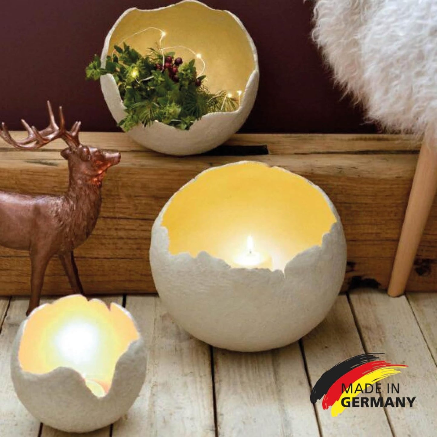 Mit LM Kreativ Bastelbeton gestaltete kugelförmige Lichtobjekte mit goldener Innenfläche als dekorative Wohnaccessoires.