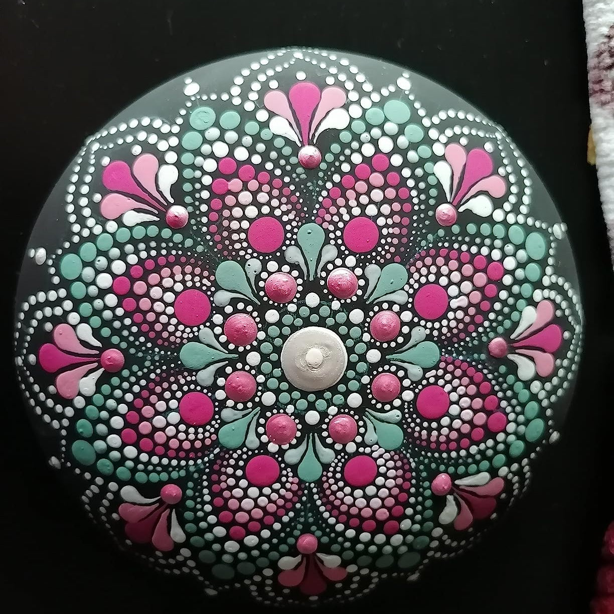 Rundes Dot Painting Mandala auf Stein in Pink, Tuerkis und Weiss mit symmetrischem Punktmuster